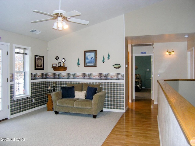 living room featuring lofted ceiling, hardwood / wood-style floors, and ceiling fan