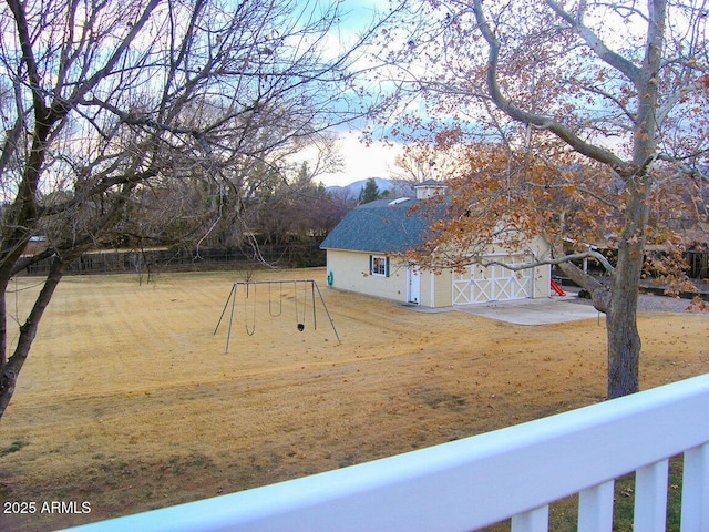 view of yard featuring an outdoor structure and a playground