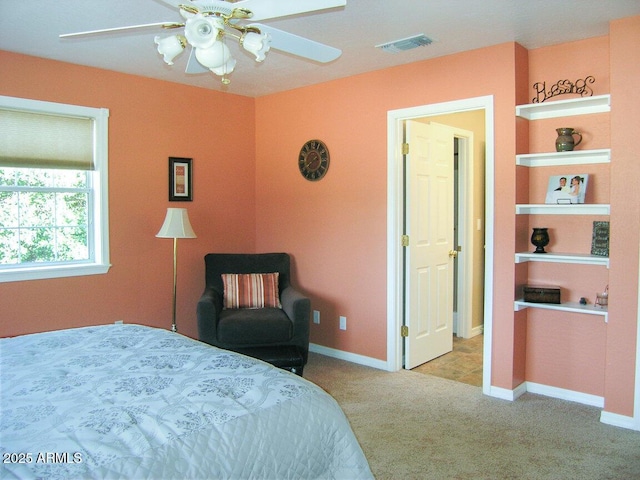 bedroom with ceiling fan and light carpet