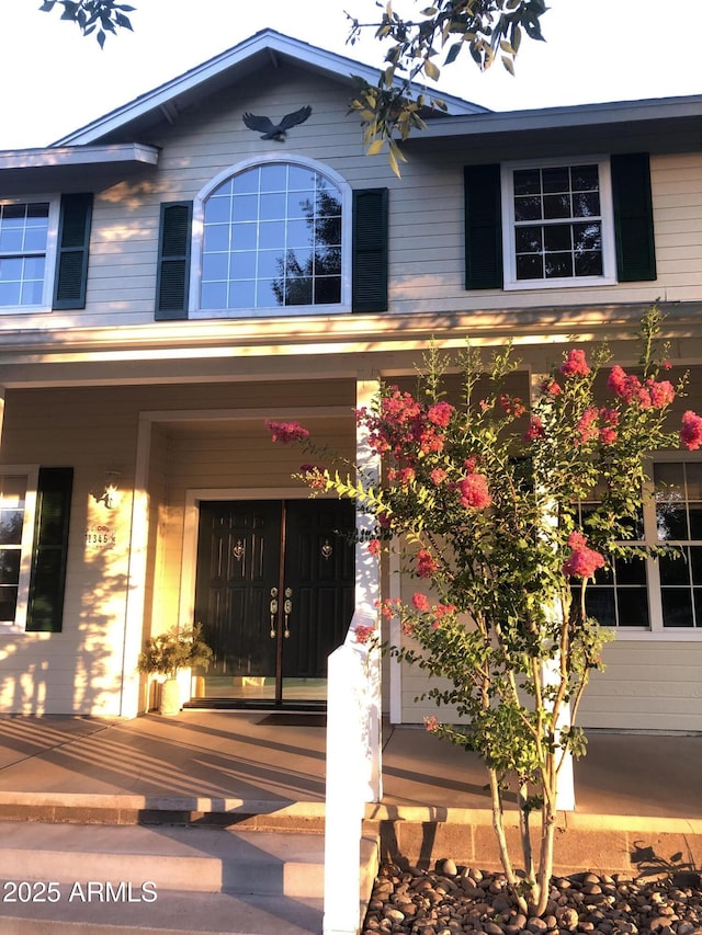 property entrance featuring covered porch