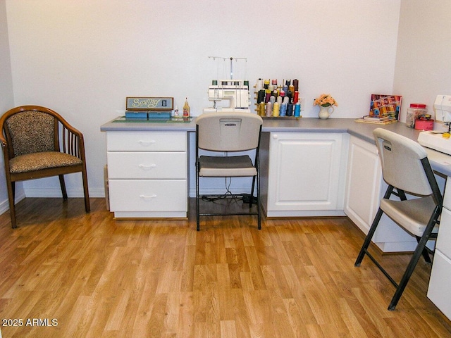 unfurnished office featuring light wood-type flooring