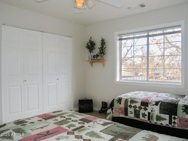 bedroom featuring multiple windows, ceiling fan, and a closet