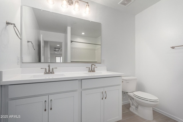 full bathroom featuring toilet, double vanity, a sink, and visible vents