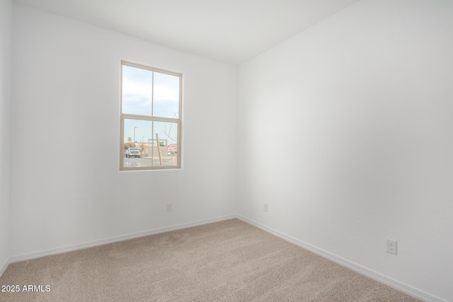 empty room with light carpet and baseboards