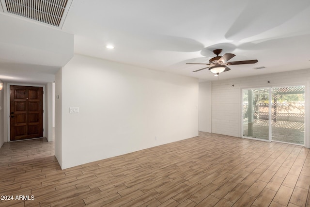 unfurnished room with ceiling fan and light wood-type flooring