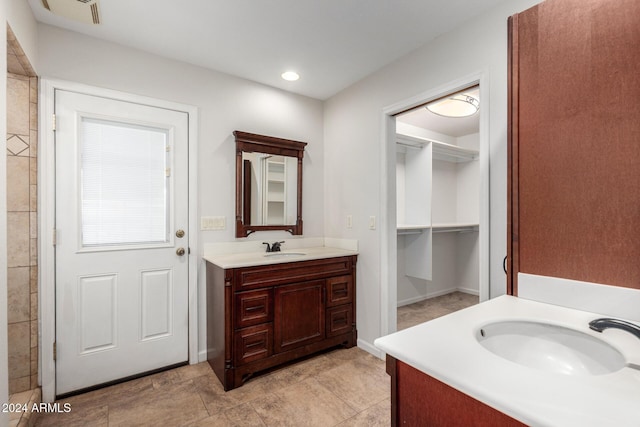 bathroom featuring tile patterned flooring and vanity