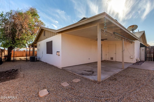 back of property with a patio area, ceiling fan, and central AC unit