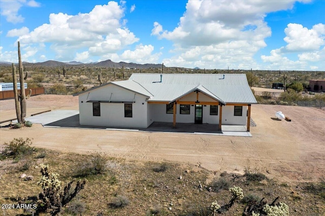 back of property with a mountain view