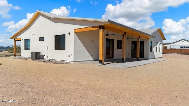 rear view of house with ceiling fan, cooling unit, and a patio area