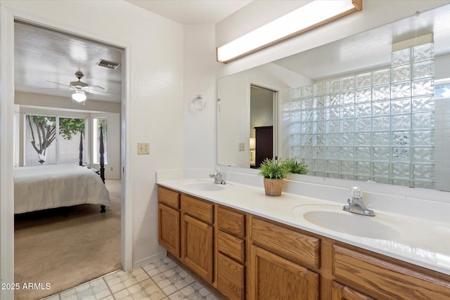 63 W Los Arboles Dr, Tempe, AZ 85284 - full bathroom with double vanity, ceiling fan, a sink, and ensuite bathroom