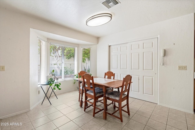 63 W Los Arboles Dr, Tempe, AZ 85284 - dining space featuring light tile patterned floors, baseboards, and visible vents