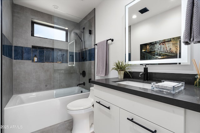 full bathroom with shower / bath combination with glass door, tile patterned floors, vanity, and toilet