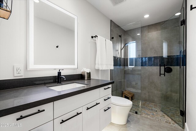 bathroom with vanity, toilet, and walk in shower