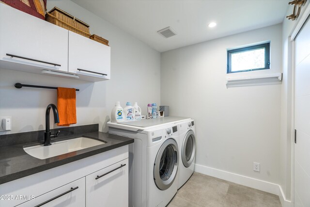 laundry area with cabinets, sink, and washing machine and dryer