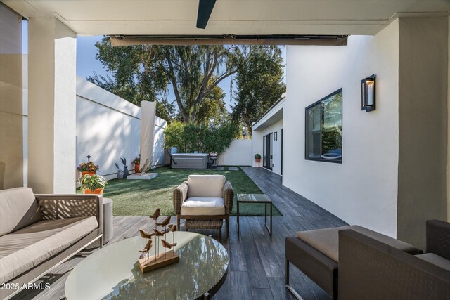 view of patio / terrace featuring outdoor lounge area, a hot tub, and ceiling fan