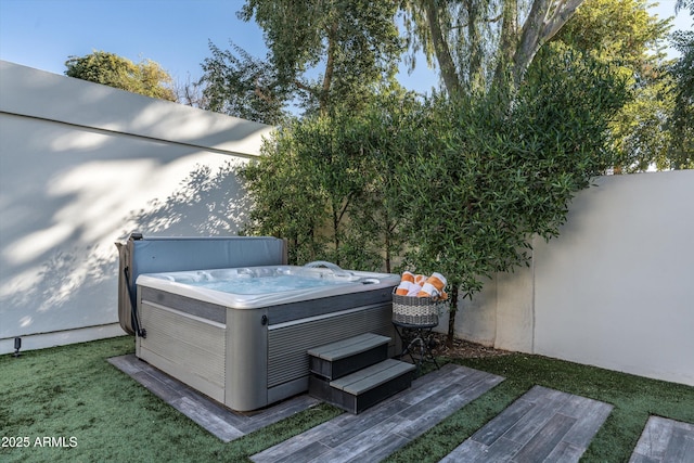 view of yard with a wooden deck and a hot tub