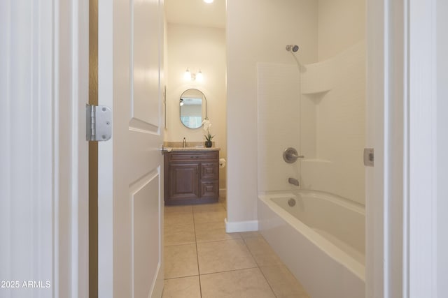 bathroom featuring tile patterned floors, washtub / shower combination, vanity, and baseboards