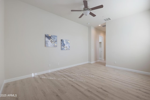 unfurnished room featuring visible vents, baseboards, ceiling fan, and light wood finished floors