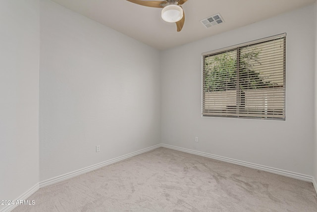 empty room with light carpet, baseboards, visible vents, and ceiling fan