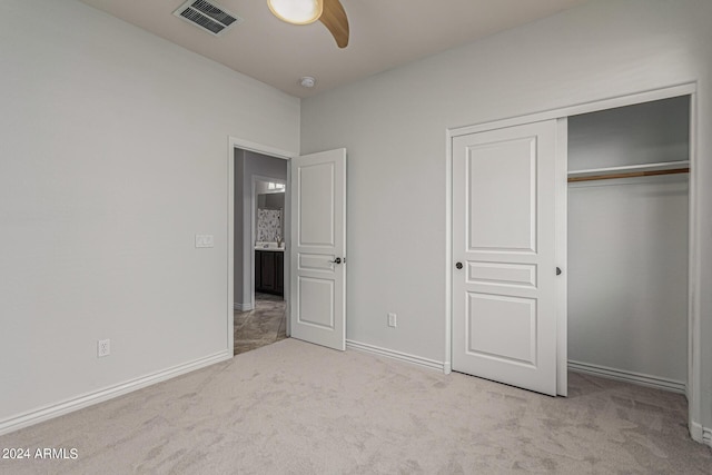 unfurnished bedroom with baseboards, a closet, visible vents, and light colored carpet