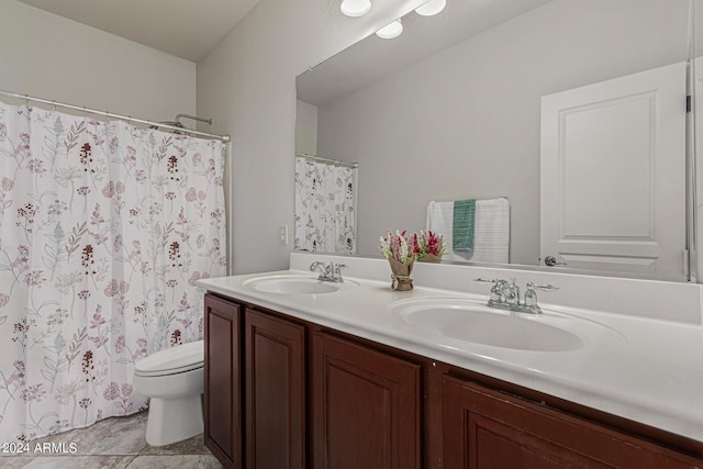 bathroom with double vanity, a shower with shower curtain, a sink, and toilet