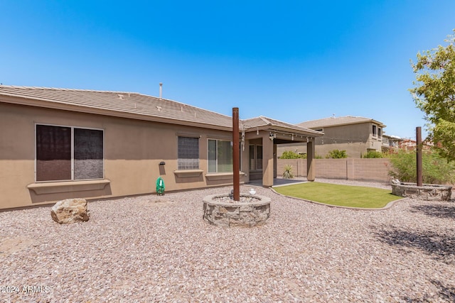 back of house with a tile roof, stucco siding, a patio, and fence