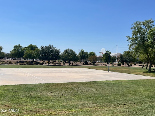 view of basketball court featuring community basketball court and a lawn