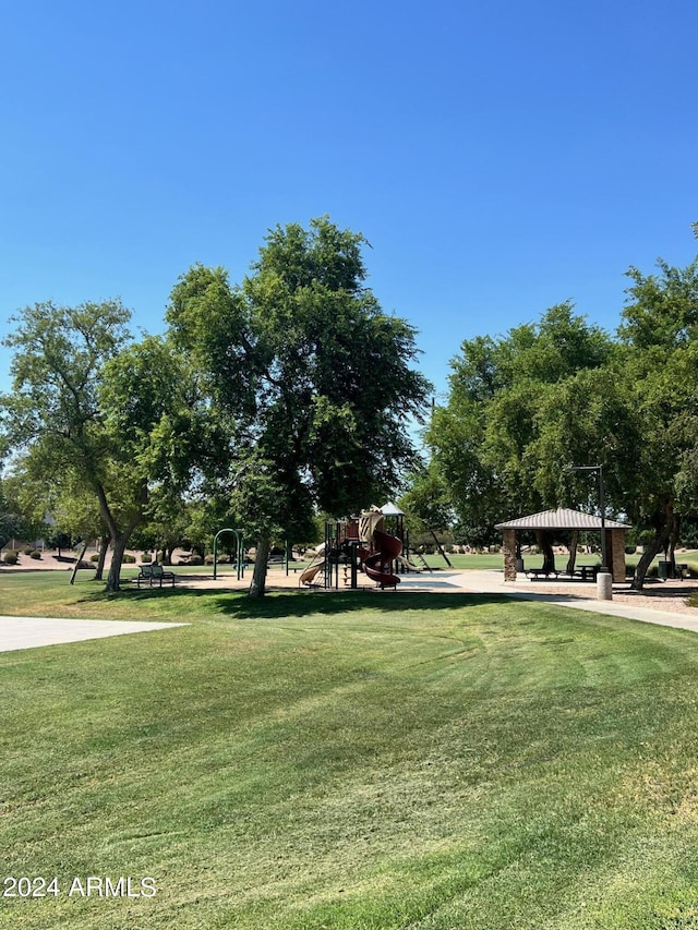 view of property's community with playground community, a yard, and a gazebo