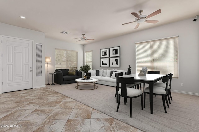 dining area with a healthy amount of sunlight, visible vents, ceiling fan, and baseboards