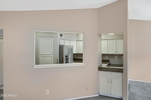 4790 E Navajo St, Phoenix, AZ 85044 - kitchen with stainless steel fridge with ice dispenser, white cabinets, baseboards, and dark countertops