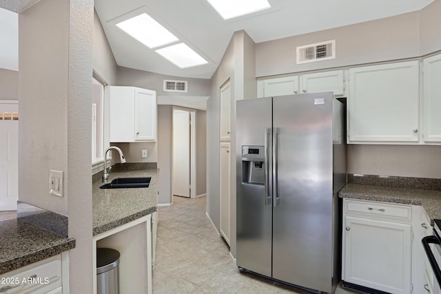 4790 E Navajo St, Phoenix, AZ 85044 - kitchen with stainless steel fridge, a sink, white cabinets, and range