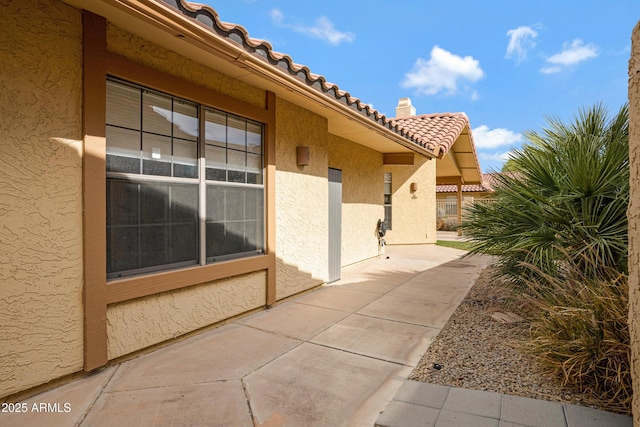 4790 E Navajo St, Phoenix, AZ 85044 - doorway to property featuring stucco siding, a tile roof, and a patio area