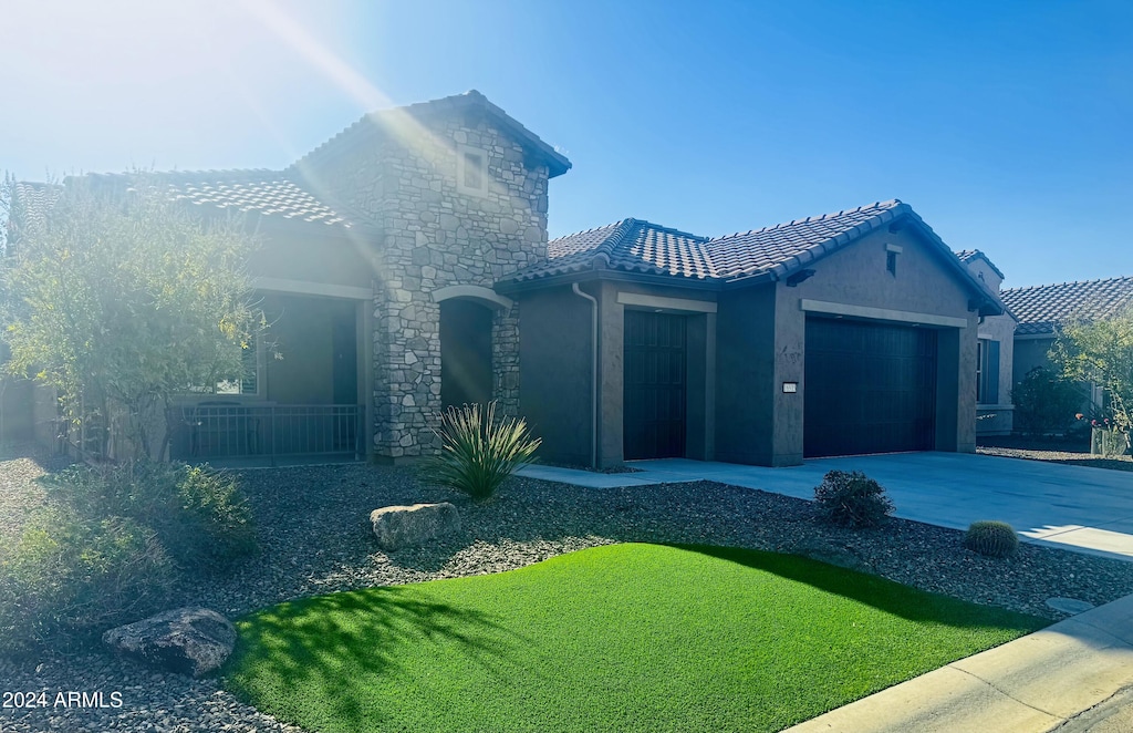 view of front of property with a garage and a front yard