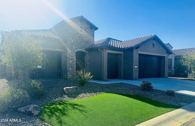 view of front of property with a garage and a front yard