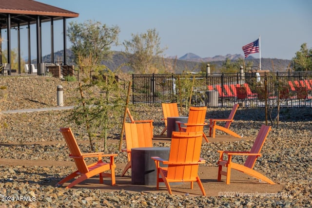 view of play area with a mountain view and an outdoor fire pit