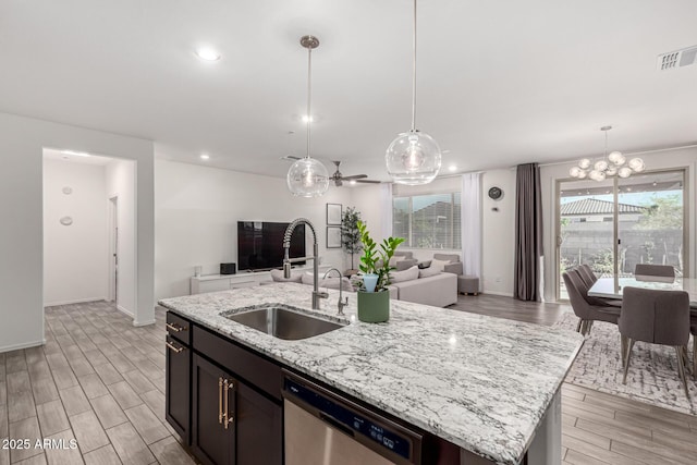 kitchen featuring open floor plan, dishwasher, visible vents, and a sink