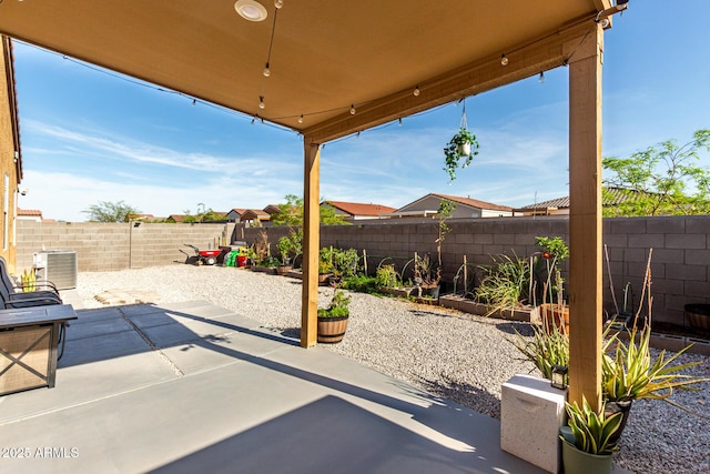 view of patio featuring central AC unit, a garden, and a fenced backyard