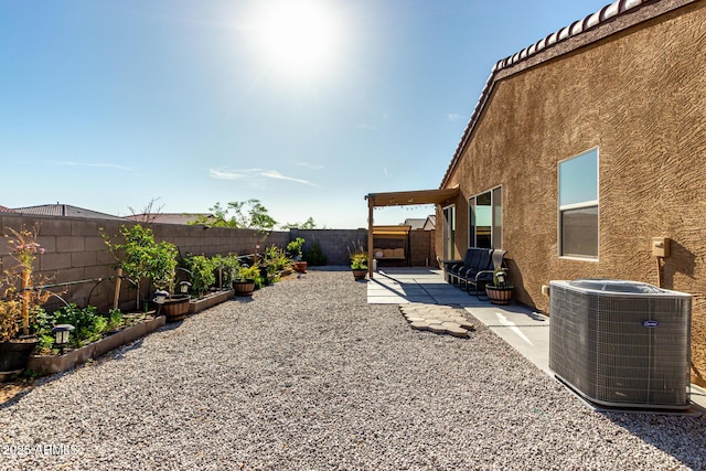 view of yard featuring a patio, a fenced backyard, and central AC unit