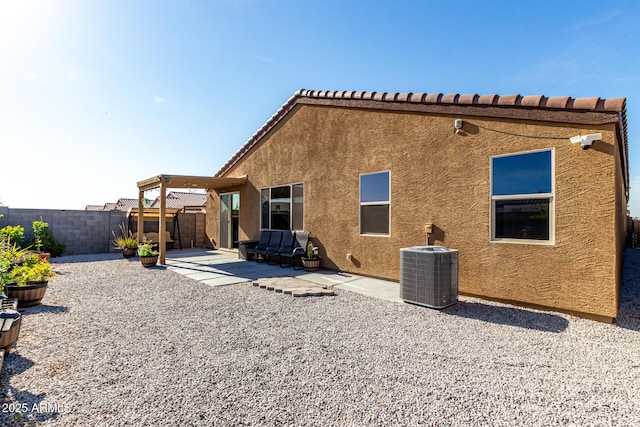 back of house with central air condition unit, a patio, a fenced backyard, and stucco siding