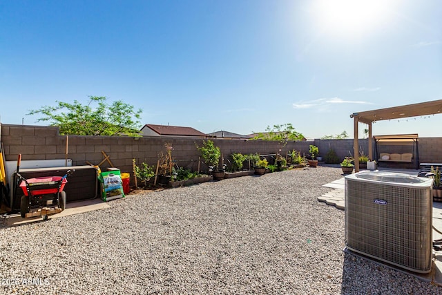 view of yard with central air condition unit and a fenced backyard