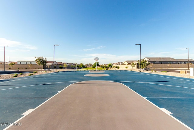 view of basketball court with a residential view and community basketball court