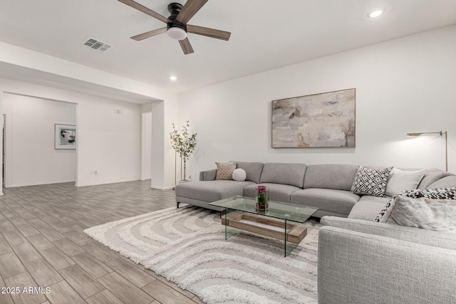 living area with recessed lighting, visible vents, wood finished floors, and ceiling fan