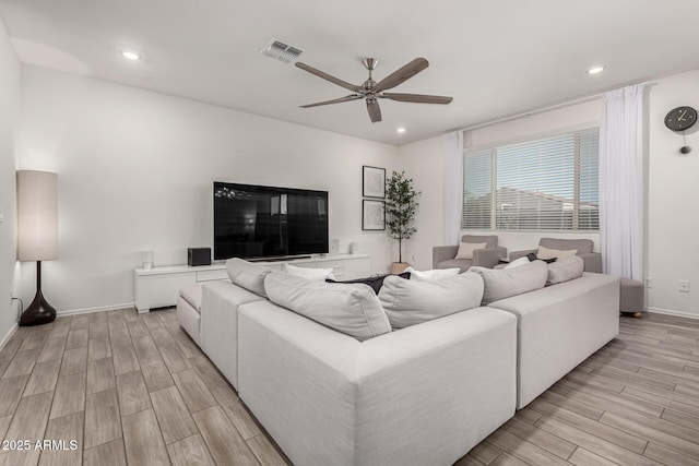 living area with light wood-type flooring, a ceiling fan, visible vents, and recessed lighting