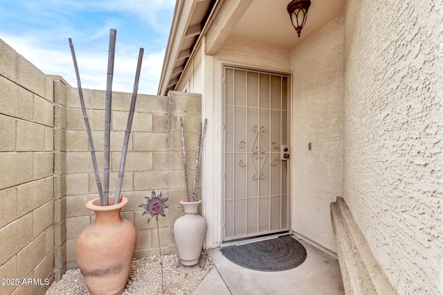 property entrance with stucco siding