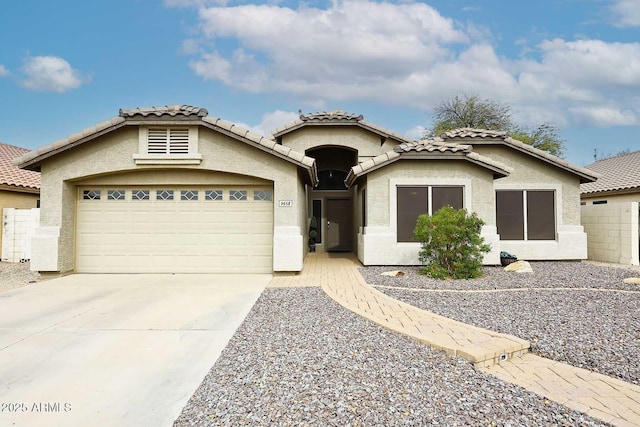 mediterranean / spanish-style house featuring stucco siding, driveway, and a garage