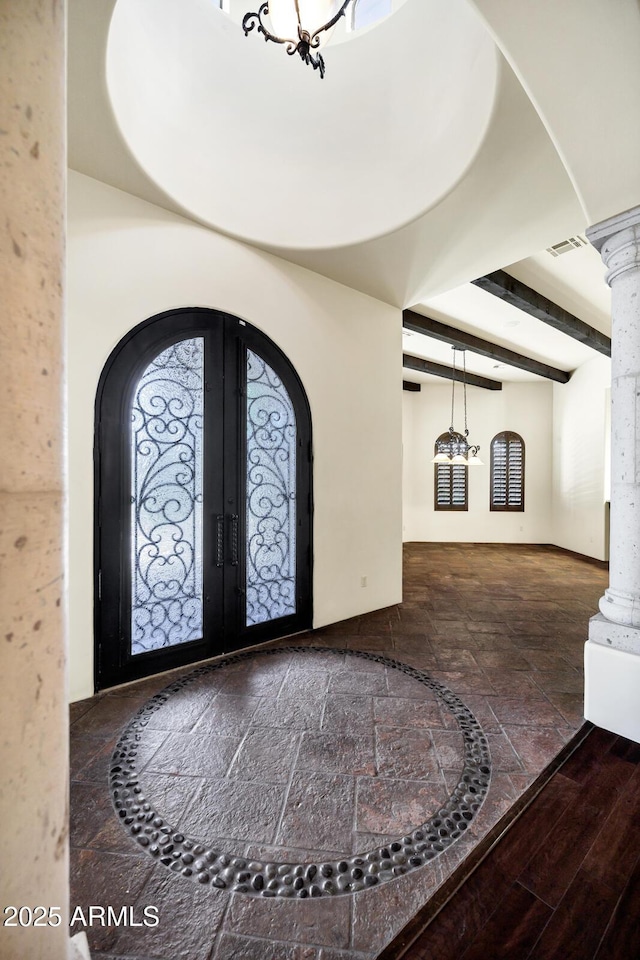 2300 E Sanoque Ct, Gilbert, AZ 85298 - entryway with decorative columns, arched walkways, french doors, stone tile flooring, and beamed ceiling