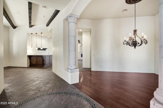 2300 E Sanoque Ct, Gilbert, AZ 85298 - unfurnished living room with ornate columns, a chandelier, beamed ceiling, arched walkways, and recessed lighting