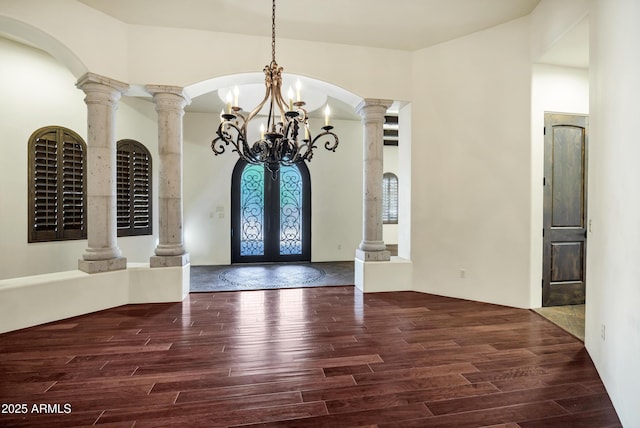 2300 E Sanoque Ct, Gilbert, AZ 85298 - foyer entrance with a chandelier, wood finished floors, decorative columns, french doors, and arched walkways