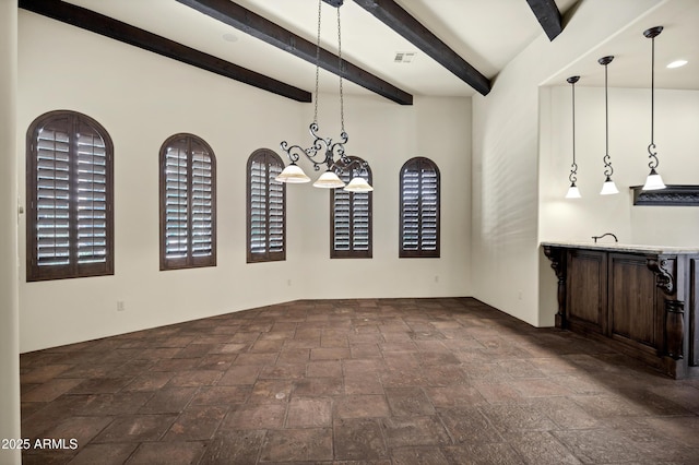 2300 E Sanoque Ct, Gilbert, AZ 85298 - unfurnished dining area with stone tile flooring, beam ceiling, and wet bar