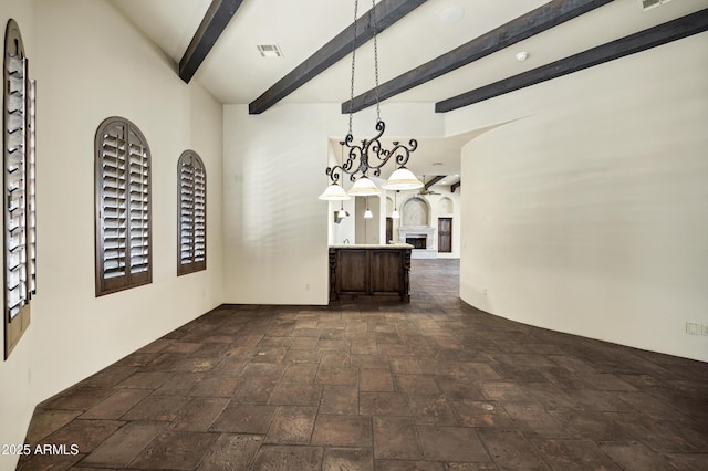 2300 E Sanoque Ct, Gilbert, AZ 85298 - unfurnished dining area featuring dark stone finish floors and beamed ceiling